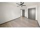 Bright bedroom with a ceiling fan, light floors and a closet for plenty of storage at 7677 Saddle Creek Trl, Sarasota, FL 34241
