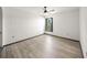 An airy bedroom with light-colored walls, and a window that streams in light at 7677 Saddle Creek Trl, Sarasota, FL 34241