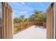 Large deck with wood railing, lush greenery, and a view of palm trees at 7677 Saddle Creek Trl, Sarasota, FL 34241