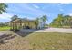 A view of the detached two-car garage with a carport and covered patio area at 7677 Saddle Creek Trl, Sarasota, FL 34241