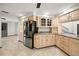 Bright kitchen featuring custom wood cabinetry, granite countertops, and stainless steel appliances at 7677 Saddle Creek Trl, Sarasota, FL 34241