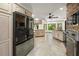Open kitchen with spacious layout, custom cabinets, granite countertops and updated appliances at 7677 Saddle Creek Trl, Sarasota, FL 34241
