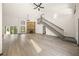 Expansive living room with a stone fireplace, high ceilings, and modern flooring at 7677 Saddle Creek Trl, Sarasota, FL 34241
