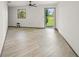 Bright living room with light floors and a back door that leads to the backyard at 7677 Saddle Creek Trl, Sarasota, FL 34241