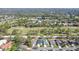 Aerial view of house in a golf community with luscious landscaping and mature trees at 7767 Pine Trace Dr, Sarasota, FL 34243