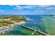 An aerial perspective showcases a stunning waterfront area with a scenic bridge and a marina at 7767 Pine Trace Dr, Sarasota, FL 34243
