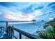A breathtaking view of the beach at sunset, with an inviting boardwalk and distant palapas at 7767 Pine Trace Dr, Sarasota, FL 34243