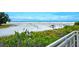 A scenic view shows a crowded beach, with plenty of people, and a view of the horizon at 7767 Pine Trace Dr, Sarasota, FL 34243