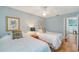 Neutral bedroom featuring twin beds, warm decor and an open door to the pool area at 7767 Pine Trace Dr, Sarasota, FL 34243