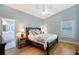 Bedroom with a ceiling fan and decorative pillows on the bed at 7767 Pine Trace Dr, Sarasota, FL 34243