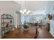Open dining area showcasing a dining table that connects to the living room with a chandelier, hardwood floors, and decor at 7767 Pine Trace Dr, Sarasota, FL 34243