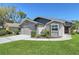 Charming single-story home featuring well-maintained landscaping and an attached garage, inviting curb appeal at 7767 Pine Trace Dr, Sarasota, FL 34243