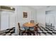 A spacious kitchen featuring black-and-white checkered floors and saloon style doors at 7767 Pine Trace Dr, Sarasota, FL 34243
