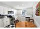 Bright kitchen features white cabinets, stainless steel appliances, and a breakfast nook with a round wooden table at 7767 Pine Trace Dr, Sarasota, FL 34243
