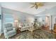 Inviting living room featuring a cozy sofa, plush armchairs, and elegant decor, perfect for relaxing and entertaining guests at 7767 Pine Trace Dr, Sarasota, FL 34243