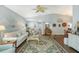 Spacious living room with hardwood floors, stylish furniture, ceiling fan, and charming decorative accents for a comfortable ambiance at 7767 Pine Trace Dr, Sarasota, FL 34243