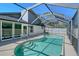 Inviting pool area within a screened enclosure, providing a refreshing oasis for relaxation and recreation at 7767 Pine Trace Dr, Sarasota, FL 34243
