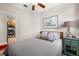 Cozy bedroom with a ceiling fan, a lamp, and an end table at 7959 Limestone Ln # 14-104, Sarasota, FL 34233