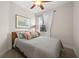 Comfortable bedroom with a ceiling fan and a window with curtains at 7959 Limestone Ln # 14-104, Sarasota, FL 34233
