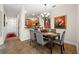 Elegant dining room featuring a chandelier, artwork and tile floors, open to the kitchen at 7959 Limestone Ln # 14-104, Sarasota, FL 34233