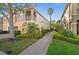 Charming multi-Gathering home with lush landscaping and a brick walkway leading to the entrance at 7959 Limestone Ln # 14-104, Sarasota, FL 34233