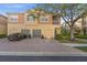 Townhome showcasing a well-kept facade with a three-car garage, driveway, and manicured landscaping at 7959 Limestone Ln # 14-104, Sarasota, FL 34233