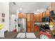Well-lit kitchen featuring stainless steel appliances, wood cabinetry, and a deep undermount sink at 7959 Limestone Ln # 14-104, Sarasota, FL 34233