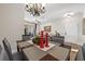 Cozy living room and dining area with a chandelier, ceiling fan and open floor plan at 7959 Limestone Ln # 14-104, Sarasota, FL 34233