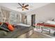 Bright main bedroom with a ceiling fan, a desk, and a window with coverings at 7959 Limestone Ln # 14-104, Sarasota, FL 34233