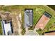 Stunning aerial view of a new construction home with a gray roof, patio, and brick driveway in a landscaped community at 8108 Wild Blue Ter, Sarasota, FL 34241