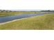 Picturesque backyard featuring a tranquil pond, a well maintained grass lawn and walking trail at 8108 Wild Blue Ter, Sarasota, FL 34241