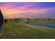 Beautiful backyard with a serene lake view and well-manicured lawn at 8108 Wild Blue Ter, Sarasota, FL 34241