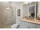 Modern bathroom featuring a glass-enclosed shower, a toilet, and a vanity with a beige countertop at 8108 Wild Blue Ter, Sarasota, FL 34241