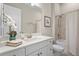 Bright bathroom with a white vanity, neutral walls, and a shower/tub combo with a curtain at 8108 Wild Blue Ter, Sarasota, FL 34241