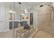 Bathroom showcasing a frameless shower, dual vanities, and a view to the walk-in closet at 8108 Wild Blue Ter, Sarasota, FL 34241