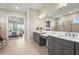 Spacious bathroom featuring double sinks, white counters and tile, and glass shower at 8108 Wild Blue Ter, Sarasota, FL 34241