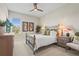 Comfortable bedroom featuring soft carpets, side tables with lamps, and an airy window view at 8108 Wild Blue Ter, Sarasota, FL 34241