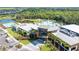 Exterior of modern clubhouse featuring a pool, lake, and palm trees creating a resort-style atmosphere at 8108 Wild Blue Ter, Sarasota, FL 34241