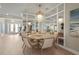 Elegant dining room featuring a round table, seating for six, decorative chandelier, and mirrored wall accents and natural light at 8108 Wild Blue Ter, Sarasota, FL 34241
