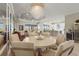 Open floor plan featuring dining area with chandelier and mirrored wall, seamlessly connecting to the kitchen and living space at 8108 Wild Blue Ter, Sarasota, FL 34241