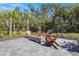 Community fire pit surrounded by chairs and lush tropical landscaping at 8108 Wild Blue Ter, Sarasota, FL 34241