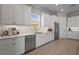 Kitchen with white cabinets, stainless steel appliances, stylish backsplash, and wood-look floors providing lots of counter space at 8108 Wild Blue Ter, Sarasota, FL 34241