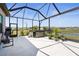 Screened lanai featuring a hot tub, workout machine, and lovely views, creating an ideal space for leisure and fitness at 8108 Wild Blue Ter, Sarasota, FL 34241