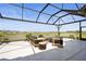 Relaxing lanai with comfortable seating, perfect for enjoying the beautiful lake views and serene outdoor living at 8108 Wild Blue Ter, Sarasota, FL 34241