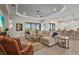 Open-concept living room with sliding doors, hardwood floors, and comfortable seating at 8108 Wild Blue Ter, Sarasota, FL 34241