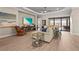 Spacious living room with hardwood floors, large windows, and comfortable seating at 8108 Wild Blue Ter, Sarasota, FL 34241