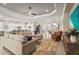Open-concept living room with hardwood floors, recessed lighting, adjacent to kitchen and dining areas at 8108 Wild Blue Ter, Sarasota, FL 34241
