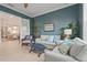 Living room with a view to the kitchen and dining area through glass panel doors at 8108 Wild Blue Ter, Sarasota, FL 34241