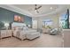 Bright main bedroom with tray ceiling, accent wall, and hardwood floors at 8108 Wild Blue Ter, Sarasota, FL 34241