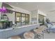 Outdoor bar featuring marble countertop, three stools, and views of the entertainment area at 8108 Wild Blue Ter, Sarasota, FL 34241